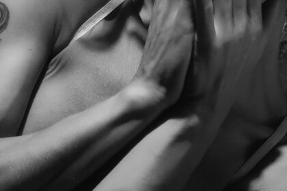 Close-up and Grayscale Photo of Woman Covering Her Mouth